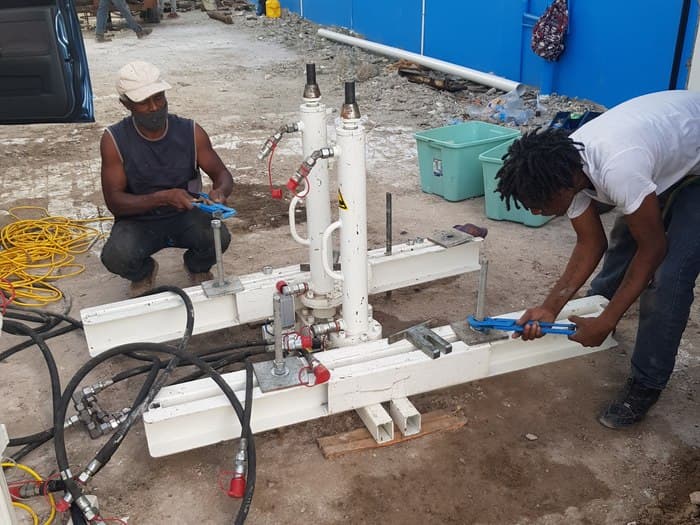 GID field crew operating a CPTu rig outside a commercial building in Castries
