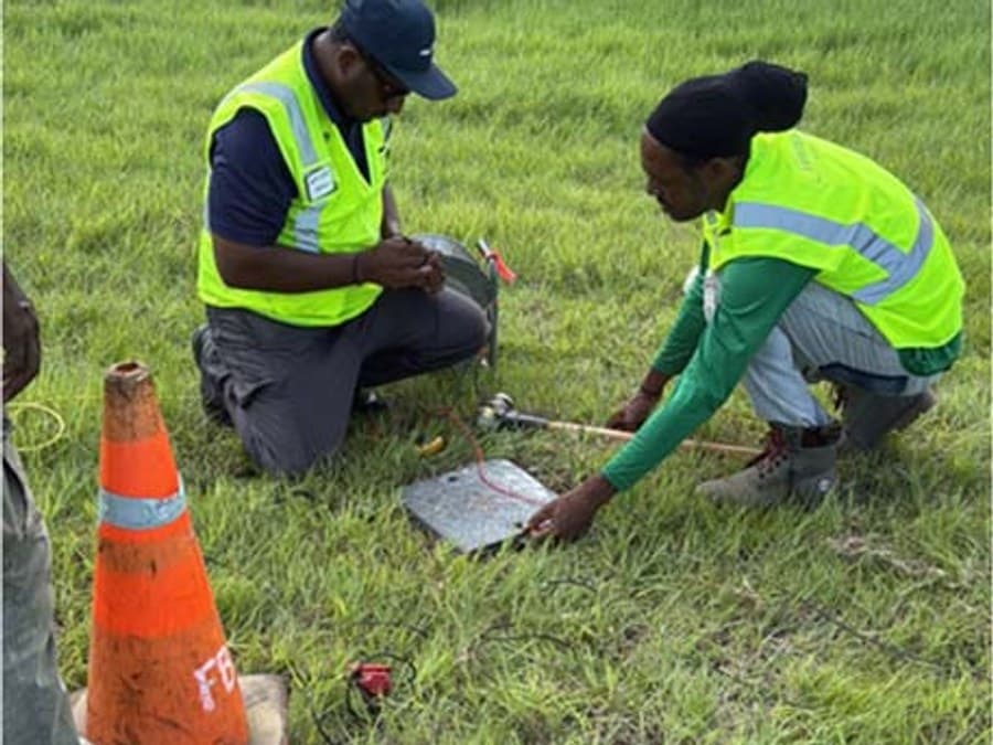 GID field technicians setting up MASW geophysical survey equipment on the airport grounds